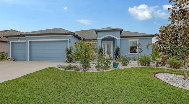 view of front of property featuring a garage and a front lawn