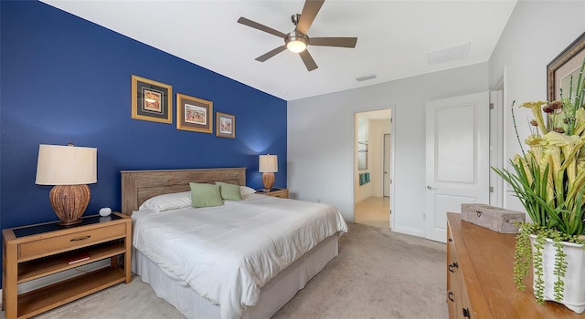 carpeted bedroom with ceiling fan and ensuite bathroom