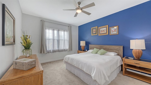 bedroom with ceiling fan and light colored carpet