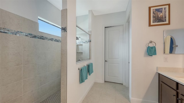 bathroom with vanity, tiled shower, and tile patterned floors