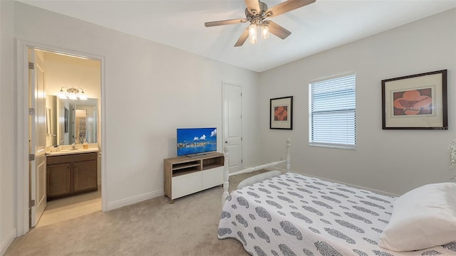 carpeted bedroom with connected bathroom and ceiling fan