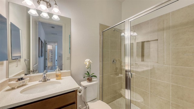 bathroom featuring vanity, toilet, and walk in shower