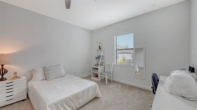 bedroom featuring light carpet and ceiling fan