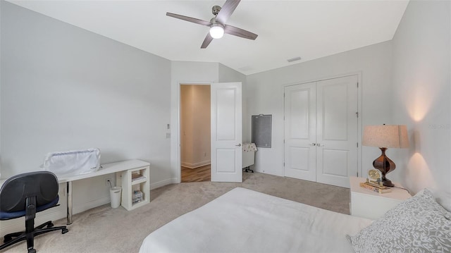 carpeted bedroom with a closet and ceiling fan