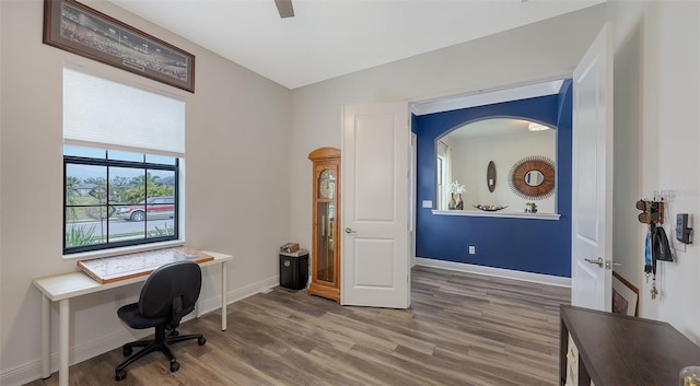 home office featuring wood-type flooring and vaulted ceiling