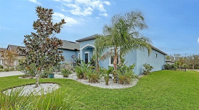 view of side of property with a lawn