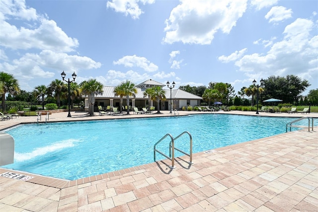 view of swimming pool with a patio area