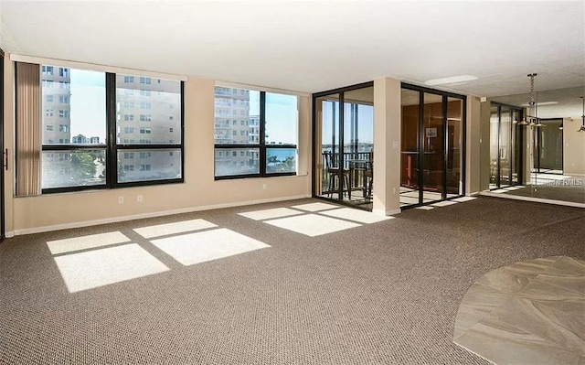 11 Sunset Dr Unit 406, Sarasota, FL 34236 - carpeted spare room with baseboards and a view of city