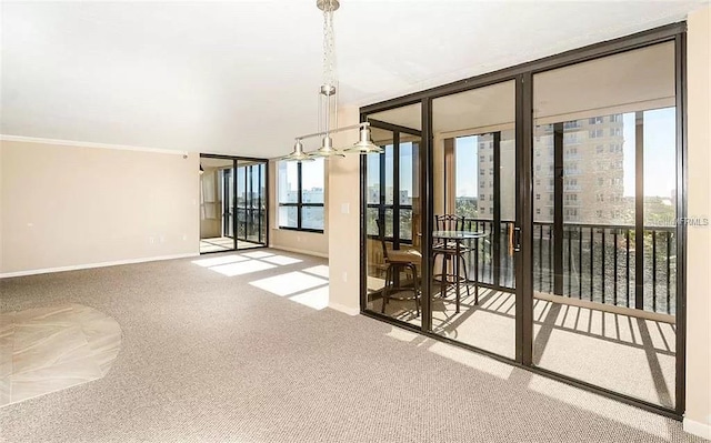 11 Sunset Dr Unit 406, Sarasota, FL 34236 - spare room featuring floor to ceiling windows, baseboards, and carpet floors