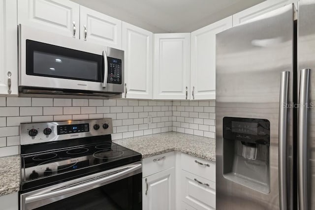 kitchen featuring light stone counters, white cabinets, and appliances with stainless steel finishes