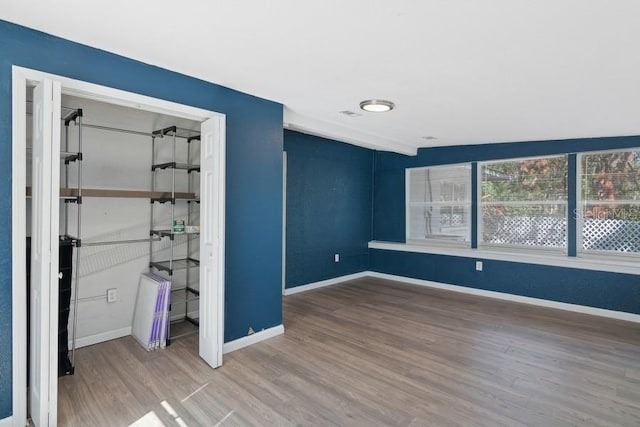 unfurnished bedroom featuring hardwood / wood-style flooring and a closet