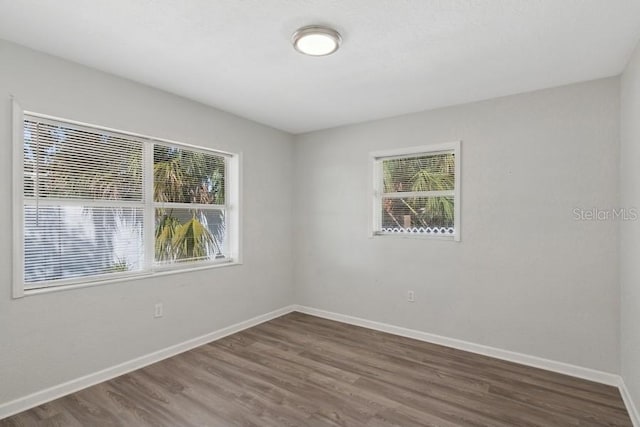 empty room featuring dark hardwood / wood-style flooring