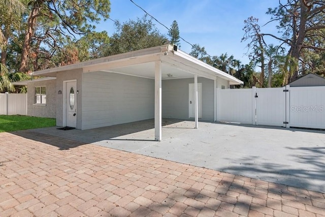 back of property featuring a carport