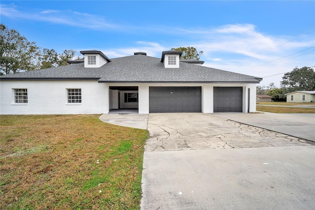 view of front of house with a garage and a front yard