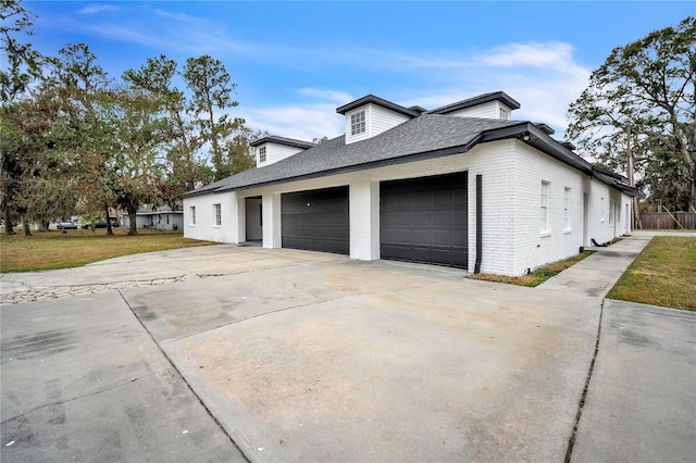 view of home's exterior with a garage and a yard