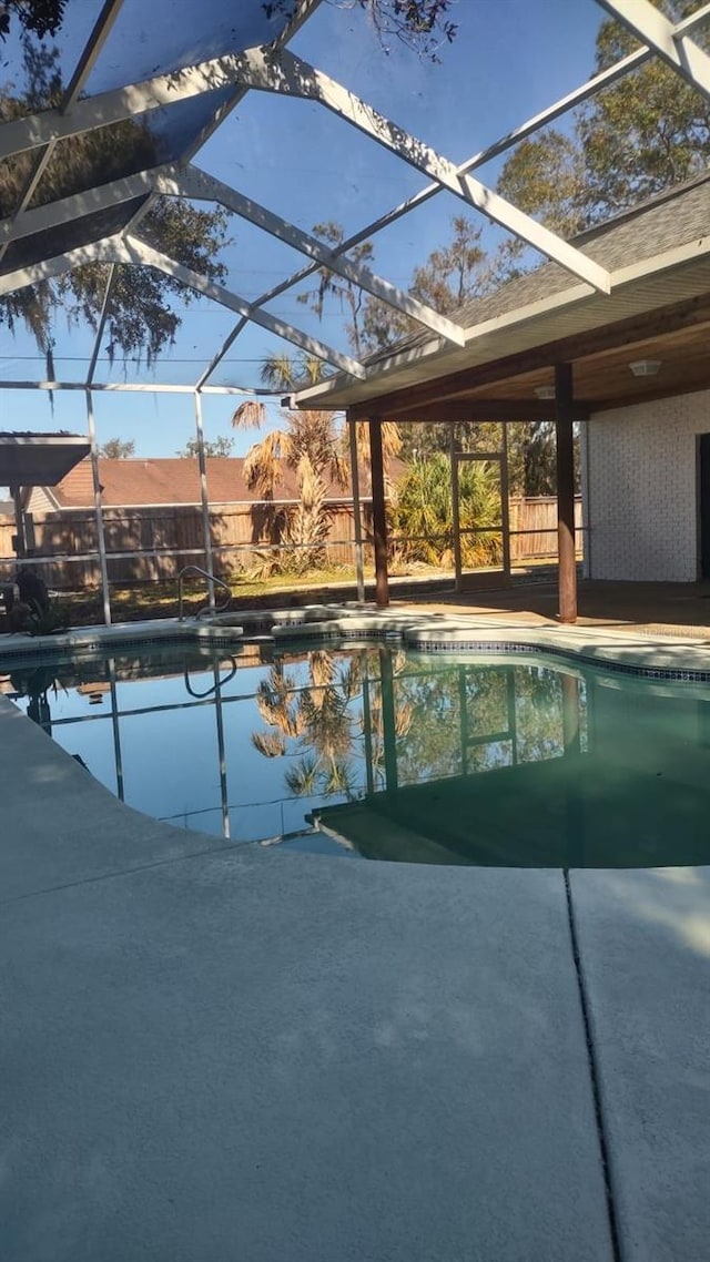 view of swimming pool with a lanai and a patio area