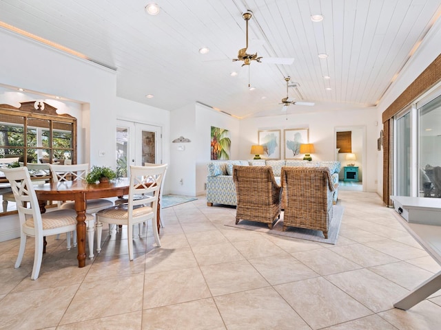 dining room with light tile patterned flooring, lofted ceiling, ceiling fan, wood ceiling, and french doors