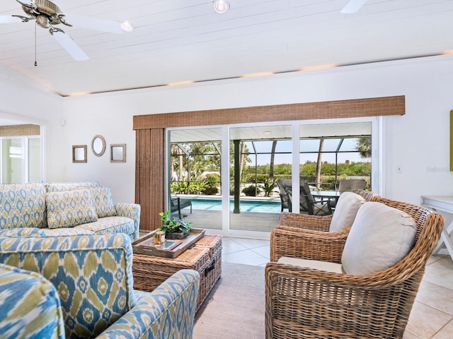 living room with light tile patterned floors, a wealth of natural light, and ceiling fan