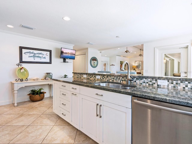 kitchen with tasteful backsplash, dishwasher, sink, dark stone countertops, and white cabinets