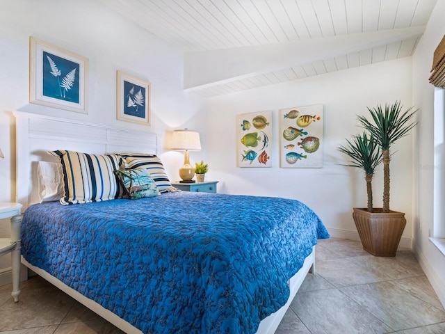 bedroom with lofted ceiling with beams, wooden ceiling, and tile patterned floors