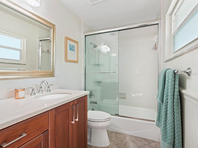 full bathroom featuring toilet, tile patterned floors, bath / shower combo with glass door, and vanity