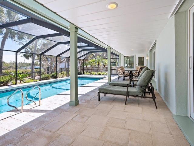 view of swimming pool featuring a patio and glass enclosure