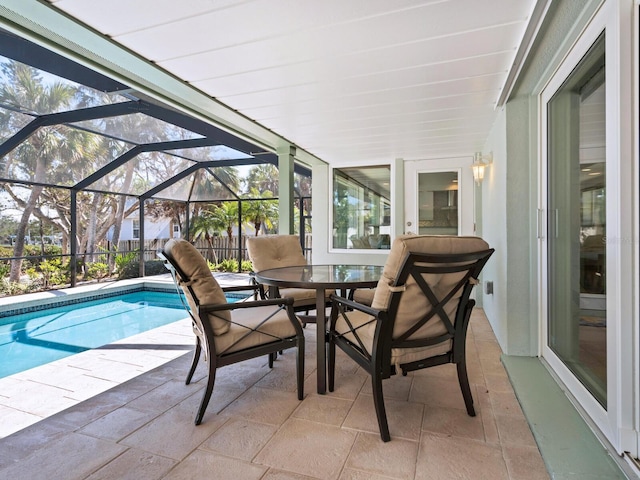 view of swimming pool featuring a patio and glass enclosure