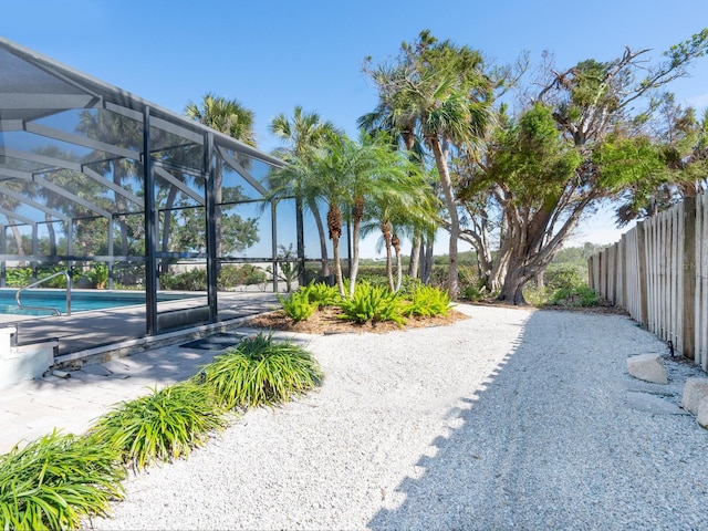 view of yard featuring a lanai and a patio area