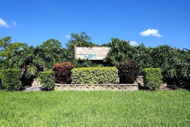 community / neighborhood sign with a lawn