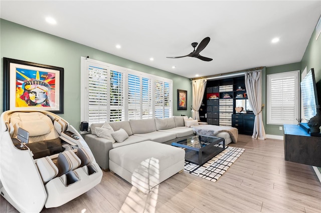 living room featuring light hardwood / wood-style floors and ceiling fan