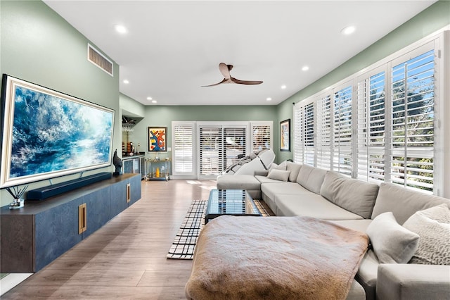 living room featuring ceiling fan and light wood-type flooring