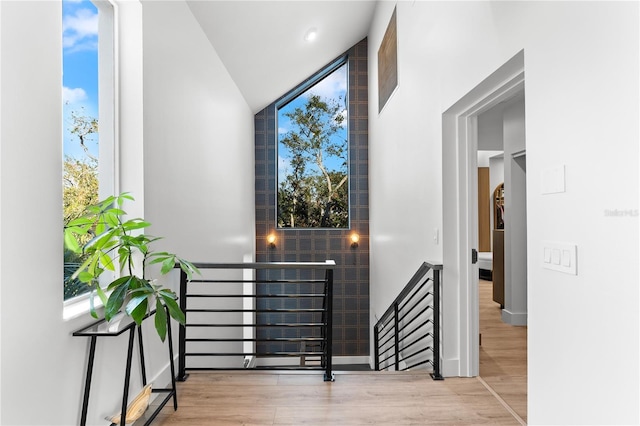 stairs featuring floor to ceiling windows and hardwood / wood-style floors