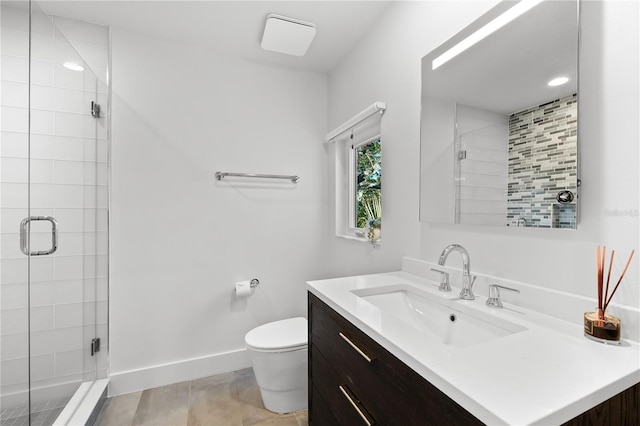 bathroom with vanity, tile patterned flooring, a shower with shower door, and toilet