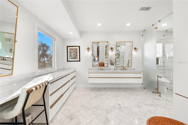 bathroom with walk in shower, vanity, and toilet