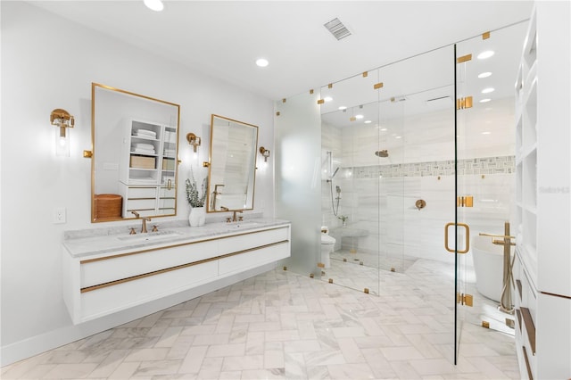 bathroom featuring vanity, toilet, and a shower with shower door