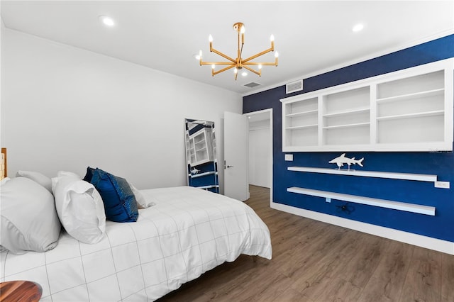 bedroom with dark hardwood / wood-style flooring and a notable chandelier