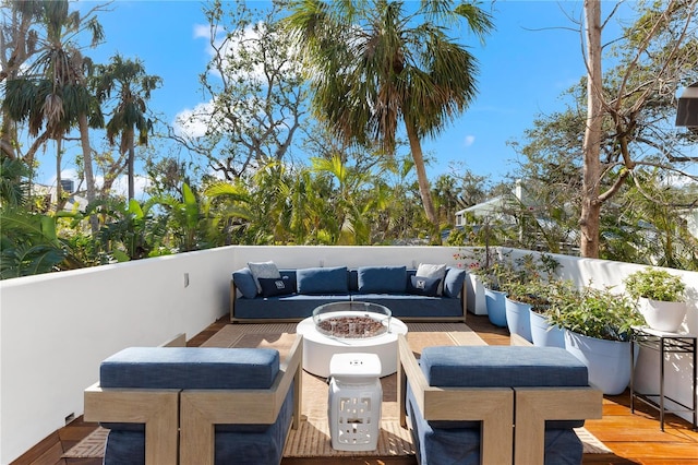 wooden deck with an outdoor living space with a fire pit