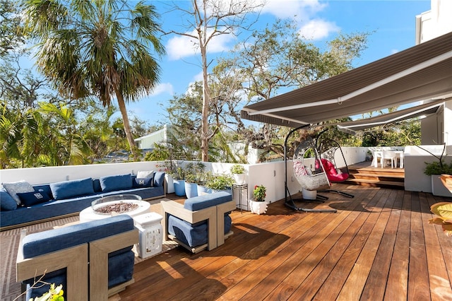 wooden terrace featuring an outdoor living space with a fire pit