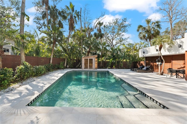 view of swimming pool with an outbuilding and a patio area