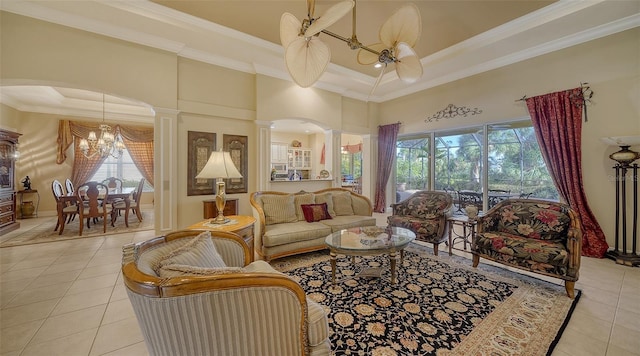 living room featuring light tile patterned flooring, ornamental molding, a tray ceiling, and ornate columns