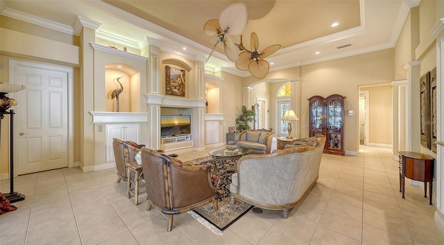 living room featuring a raised ceiling, light tile patterned flooring, and crown molding