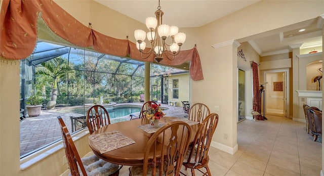 tiled dining room featuring a notable chandelier and ornamental molding