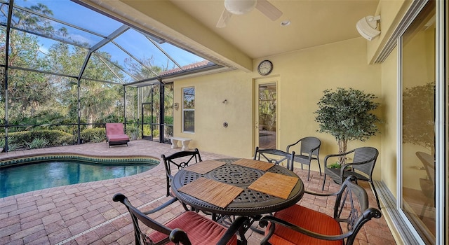 view of pool featuring a patio area, ceiling fan, and glass enclosure