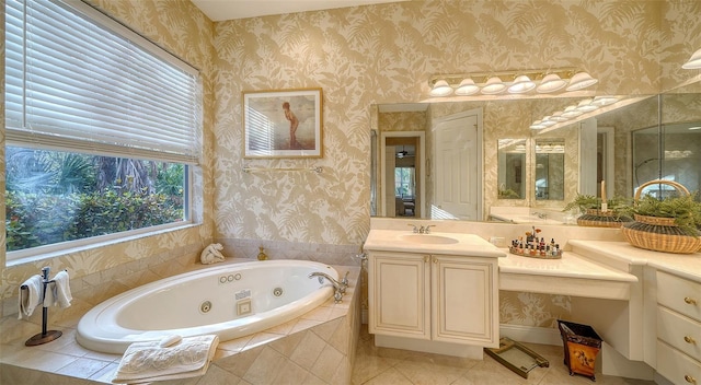 bathroom with tiled tub, vanity, and tile patterned floors