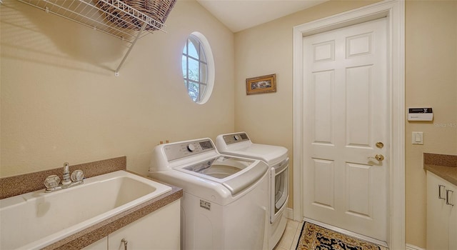 laundry area featuring light tile patterned flooring, sink, and washer and clothes dryer