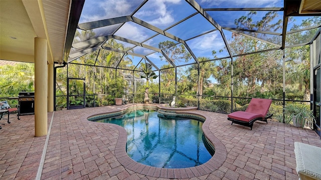 view of pool with area for grilling, a patio area, and glass enclosure