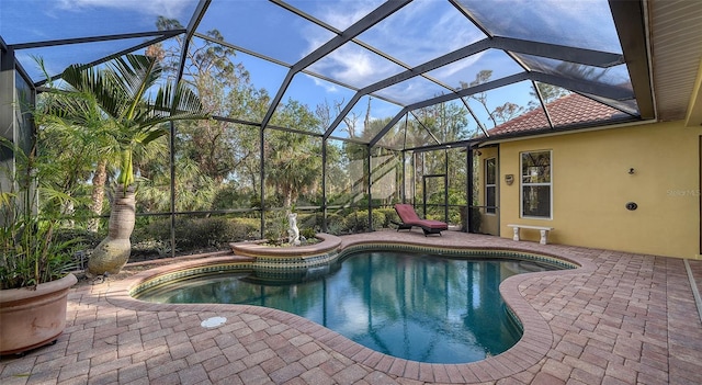 view of pool with a lanai and a patio