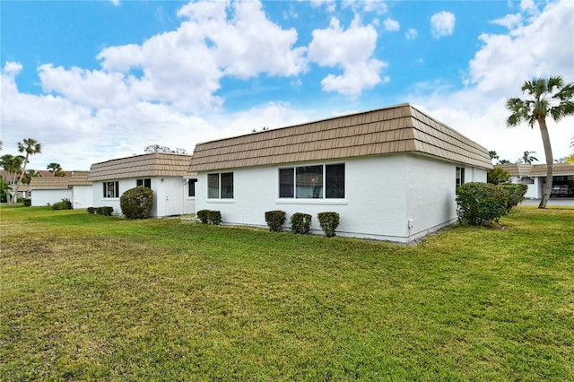 rear view of property featuring a yard