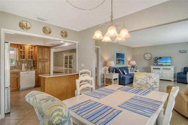 dining space featuring a chandelier and light tile patterned flooring