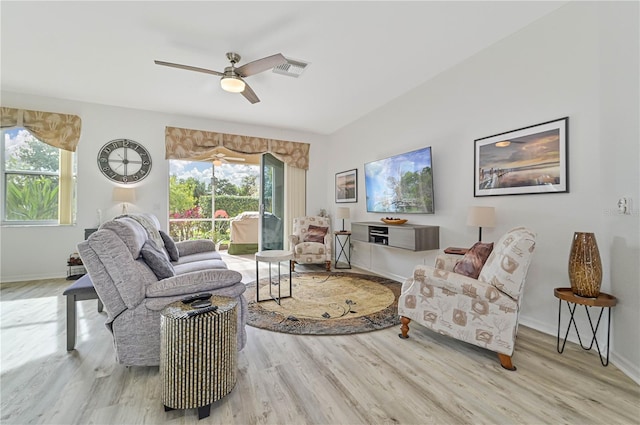 living room with ceiling fan and light hardwood / wood-style flooring